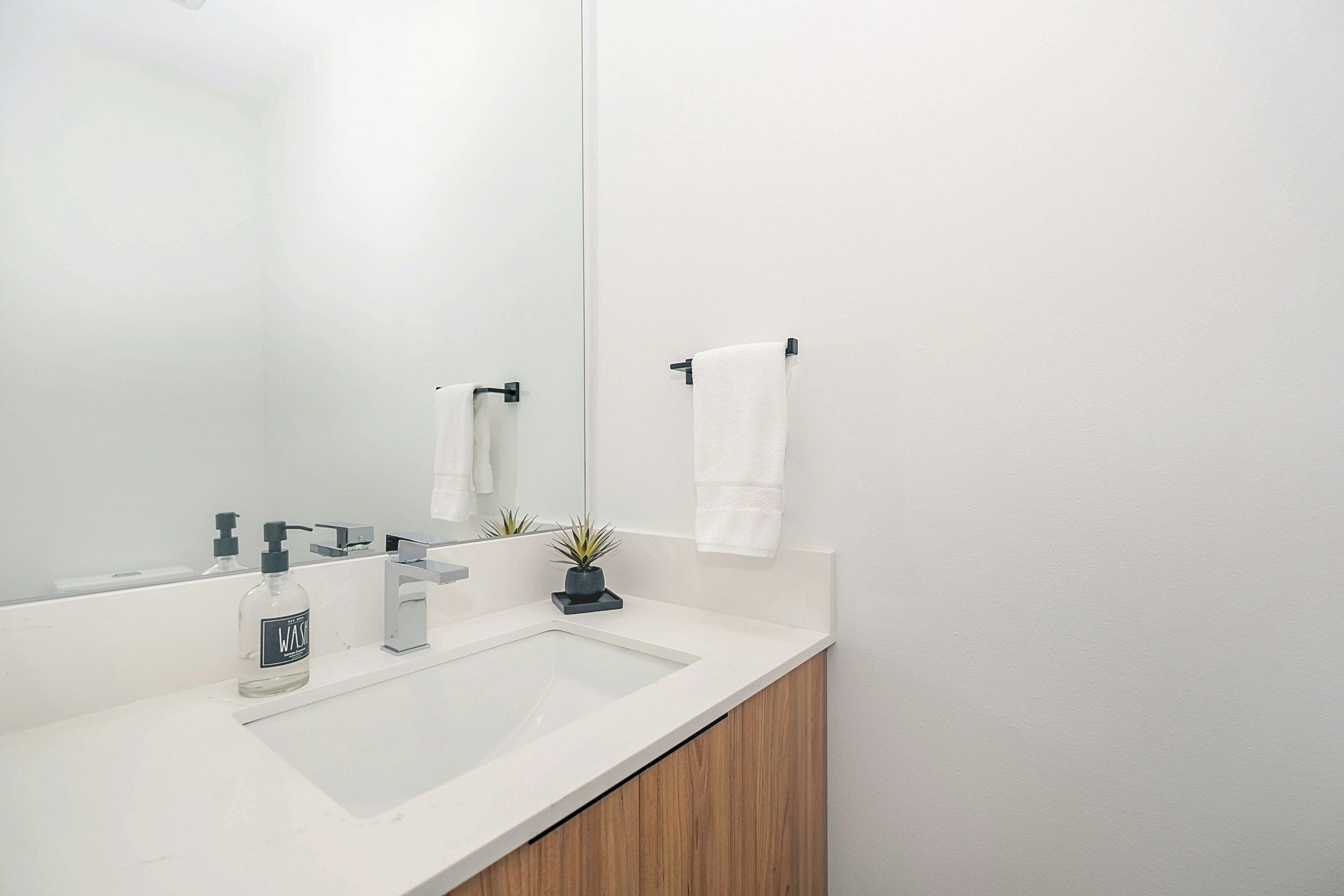 White bathroom sink with wood texture