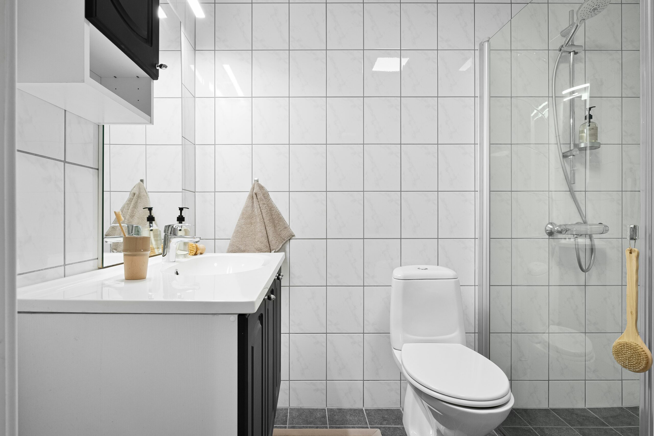 View of bathroom with sink, toilet and shower